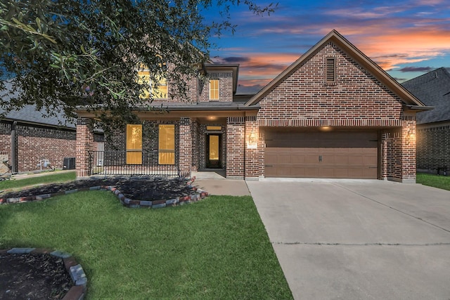 traditional-style house featuring brick siding, concrete driveway, covered porch, a garage, and a front lawn