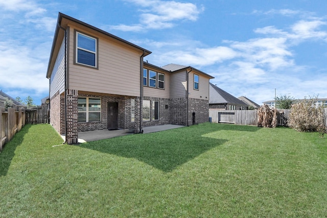 rear view of house featuring brick siding, a lawn, a patio area, and a fenced backyard