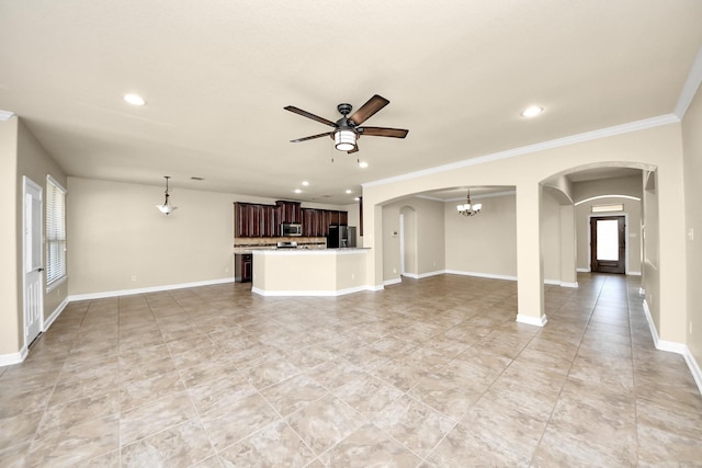 unfurnished living room featuring ceiling fan with notable chandelier, baseboards, arched walkways, and recessed lighting