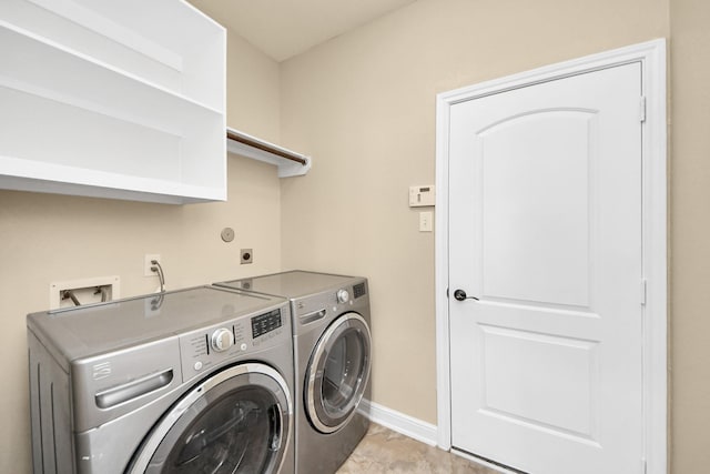 laundry area with washer and dryer, laundry area, and baseboards