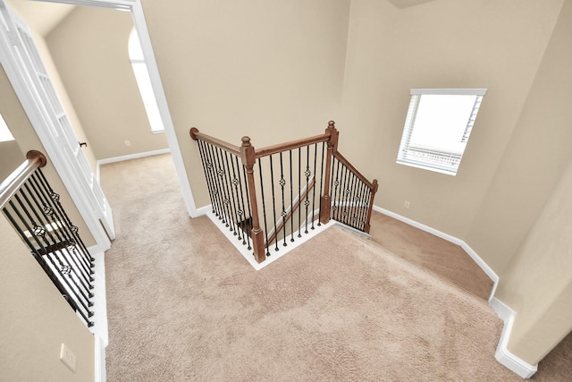 stairs featuring carpet and baseboards