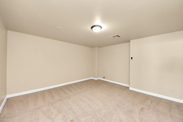 carpeted empty room featuring visible vents and baseboards