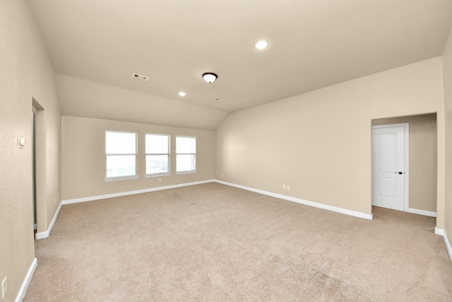 carpeted spare room with lofted ceiling, recessed lighting, visible vents, and baseboards