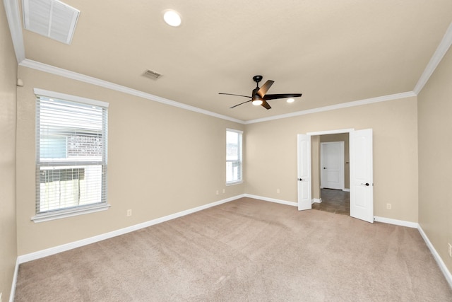 unfurnished bedroom with carpet, visible vents, baseboards, and ornamental molding