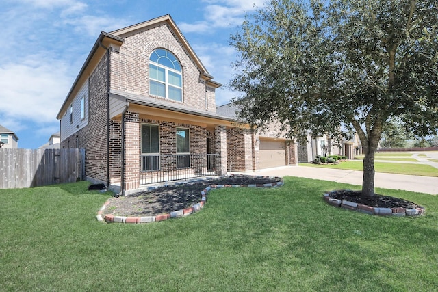 traditional-style home with driveway, brick siding, a front lawn, and fence