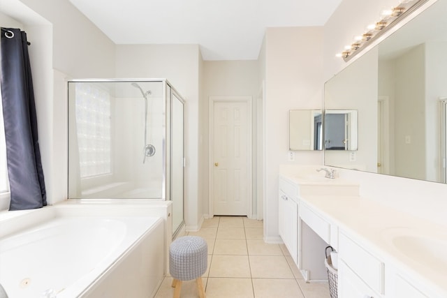 full bathroom with double vanity, a stall shower, a sink, tile patterned floors, and a bath