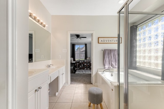 bathroom with double vanity, a healthy amount of sunlight, ensuite bath, and tile patterned floors