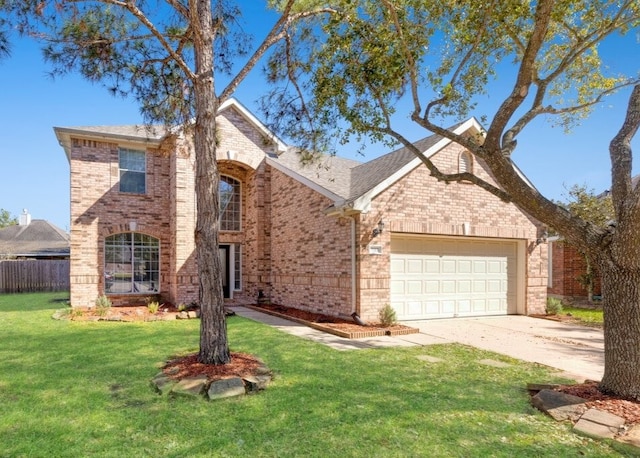 traditional home with brick siding, fence, a front yard, a garage, and driveway