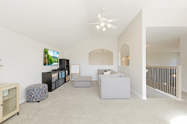 carpeted living room featuring lofted ceiling, baseboards, and ceiling fan