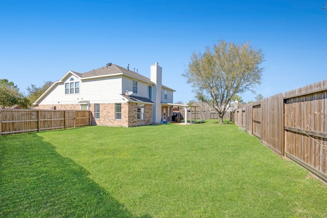 view of yard with a fenced backyard