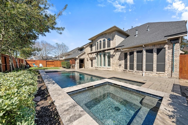 view of pool featuring a fenced in pool, a patio area, a fenced backyard, and an in ground hot tub