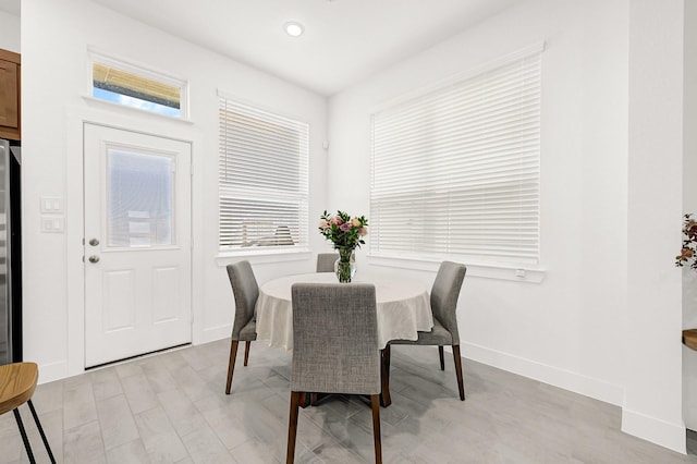 dining space with a healthy amount of sunlight and baseboards