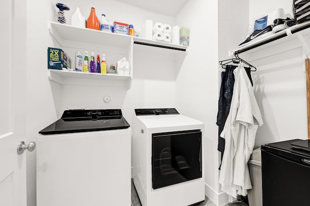 washroom with laundry area and independent washer and dryer