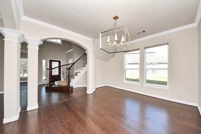 interior space with visible vents, decorative columns, baseboards, and wood finished floors