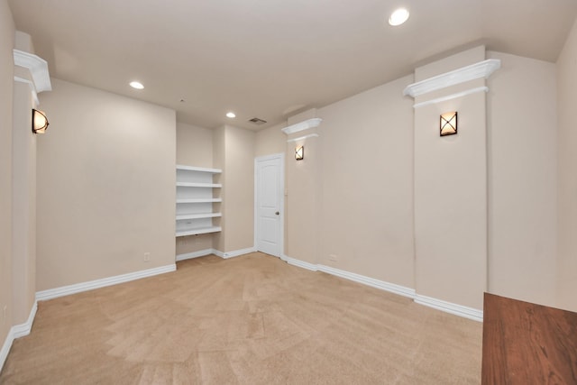 basement featuring visible vents, baseboards, light colored carpet, and recessed lighting