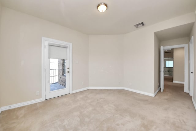 empty room with light carpet, baseboards, and visible vents