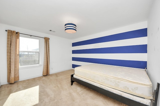 carpeted bedroom featuring baseboards and visible vents