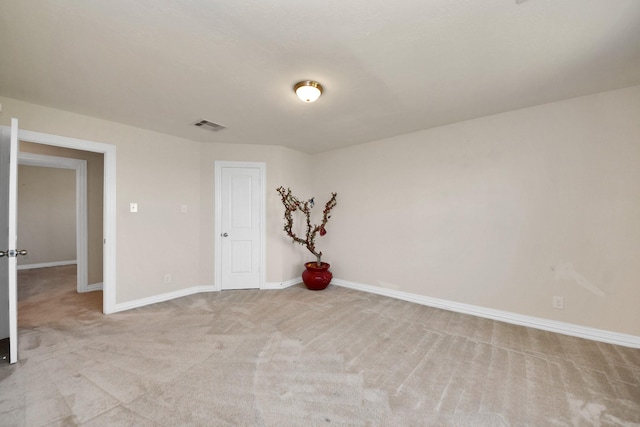 unfurnished room featuring baseboards, visible vents, and light colored carpet