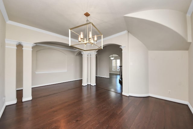 unfurnished dining area with baseboards, arched walkways, wood finished floors, vaulted ceiling, and ornate columns