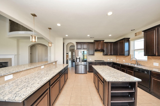 kitchen featuring gas cooktop, a kitchen island, stainless steel refrigerator with ice dispenser, dishwasher, and open shelves