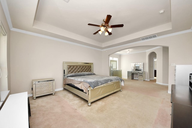 bedroom with arched walkways, a raised ceiling, visible vents, light carpet, and baseboards