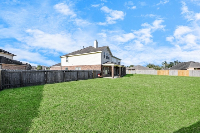 view of yard featuring a patio and a fenced backyard