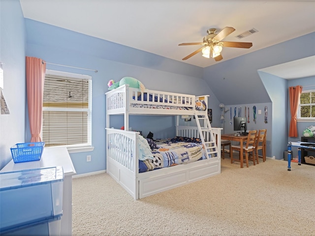 bedroom featuring a ceiling fan, vaulted ceiling, carpet, and visible vents