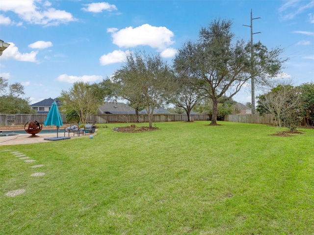 view of yard featuring a fenced in pool, a patio, and a fenced backyard