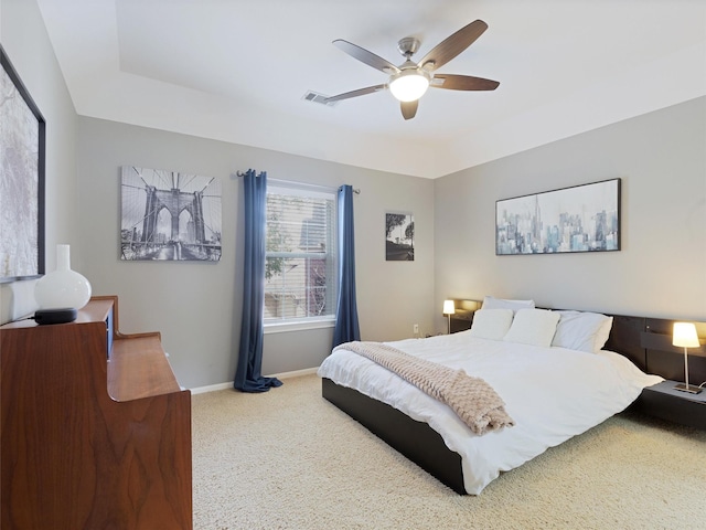 carpeted bedroom with a ceiling fan, visible vents, and baseboards