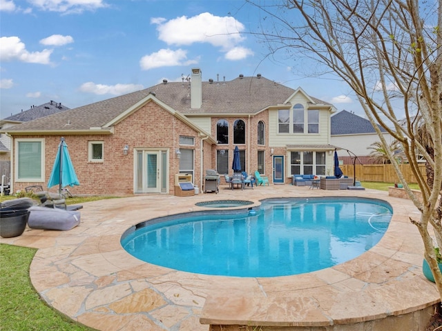 view of pool featuring a fenced in pool, fence, an in ground hot tub, grilling area, and a patio area