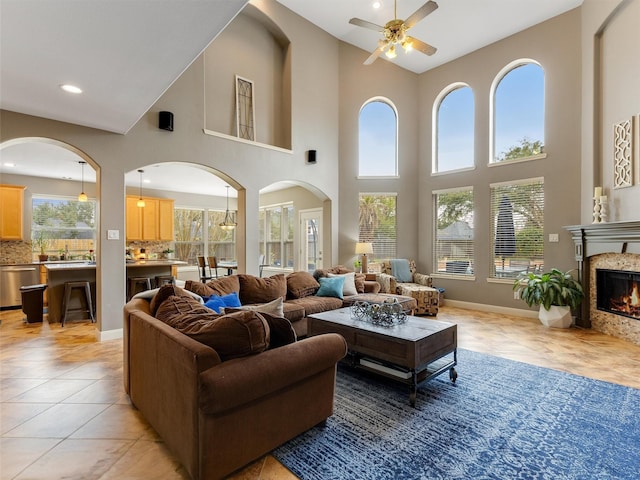 living area featuring a high end fireplace, recessed lighting, light tile patterned floors, baseboards, and ceiling fan