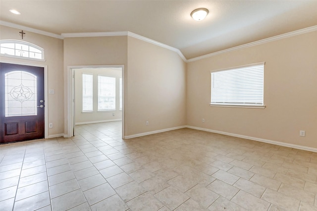 foyer with a wealth of natural light, light tile patterned flooring, crown molding, and baseboards