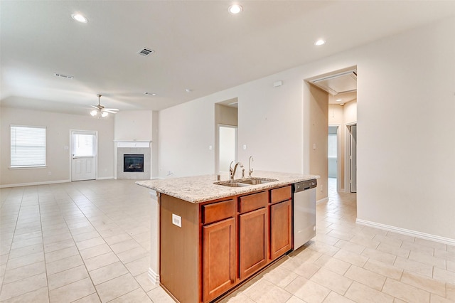 kitchen featuring a sink, visible vents, a ceiling fan, stainless steel dishwasher, and brown cabinets