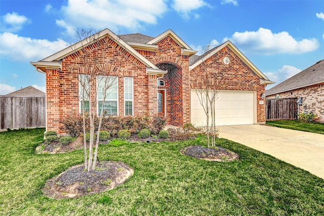 traditional-style house with driveway, fence, a front lawn, and brick siding