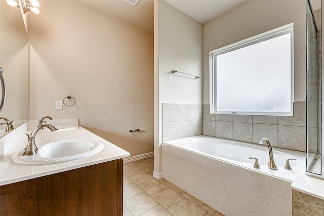 full bath featuring a bath, tile patterned flooring, double vanity, and a sink