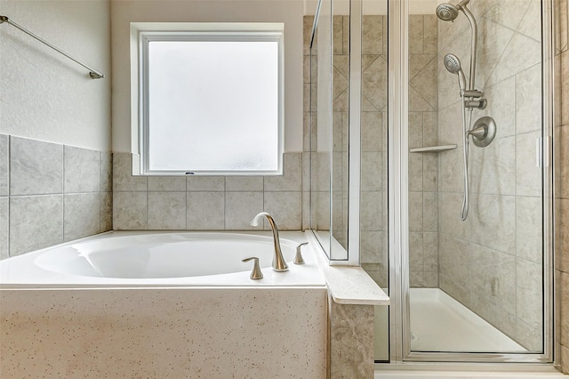 full bath featuring a garden tub and a shower stall