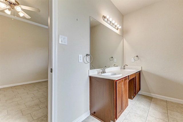 bathroom with a ceiling fan, tile patterned flooring, a sink, and baseboards