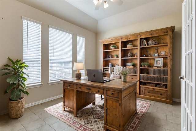 home office with a ceiling fan, light tile patterned flooring, and baseboards