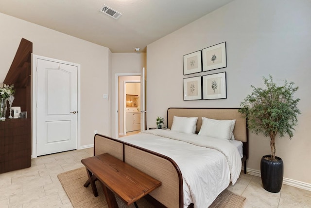 bedroom with washer / dryer, baseboards, and visible vents