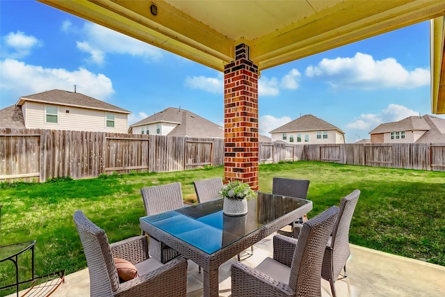 view of patio with outdoor dining space, a fenced backyard, and a residential view