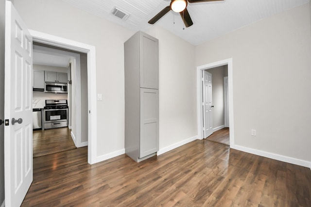 unfurnished bedroom with visible vents, dark wood finished floors, baseboards, and ceiling fan