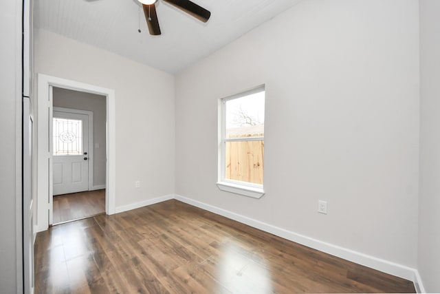 unfurnished room with ceiling fan, baseboards, and dark wood-style flooring