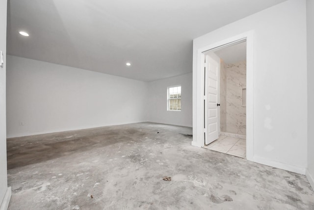 unfurnished room with recessed lighting and unfinished concrete flooring