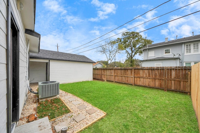 view of yard with central AC and a fenced backyard