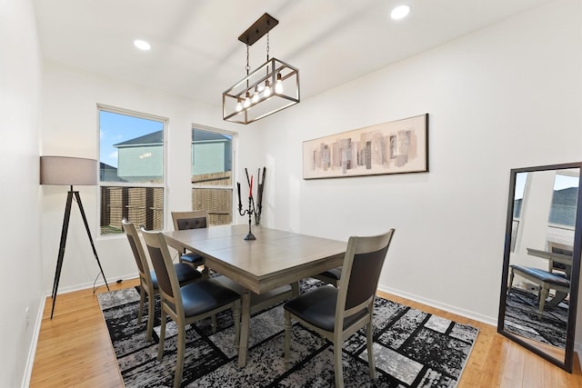 dining area with baseboards, light wood-type flooring, and recessed lighting