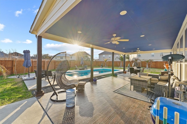 view of patio / terrace with ceiling fan, a fenced backyard, an outdoor living space, a fenced in pool, and outdoor dining space