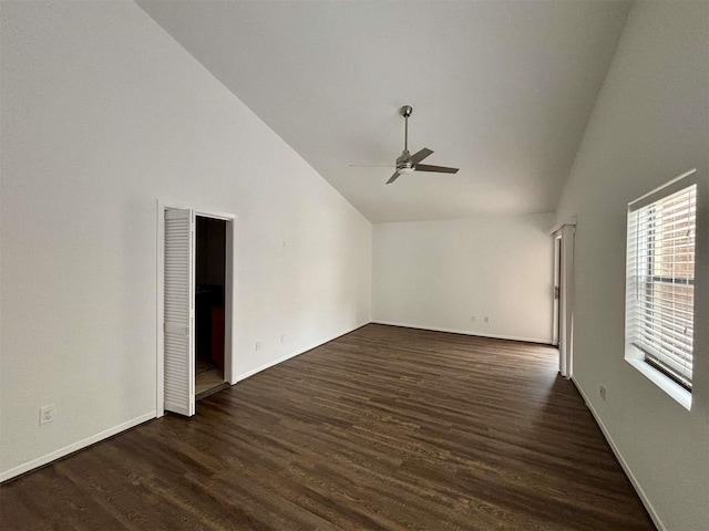 unfurnished living room with ceiling fan, high vaulted ceiling, dark wood-style flooring, and baseboards