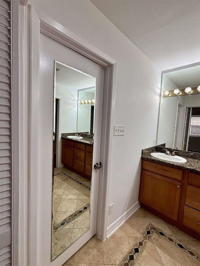 bathroom featuring baseboards and vanity