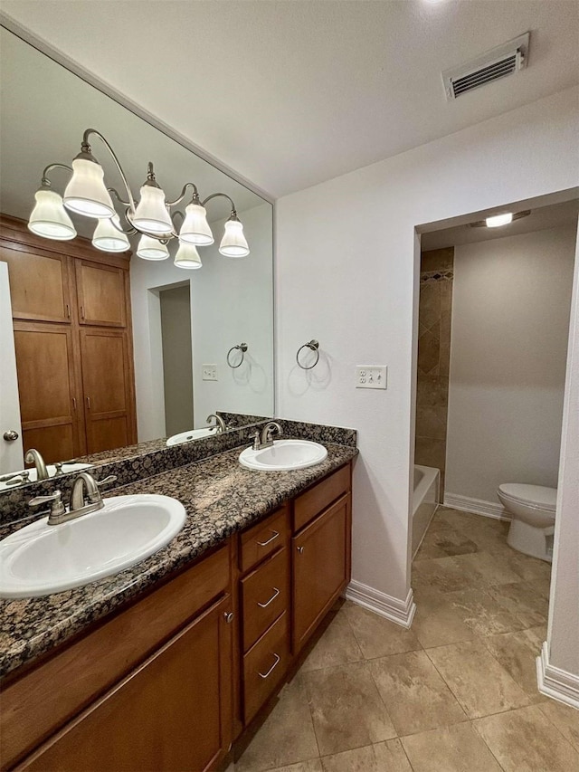 full bathroom with toilet, double vanity, visible vents, and a sink