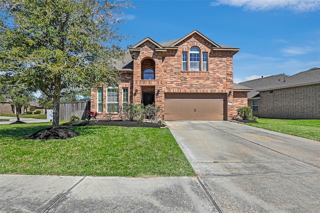 traditional-style home with driveway, an attached garage, fence, a front lawn, and brick siding